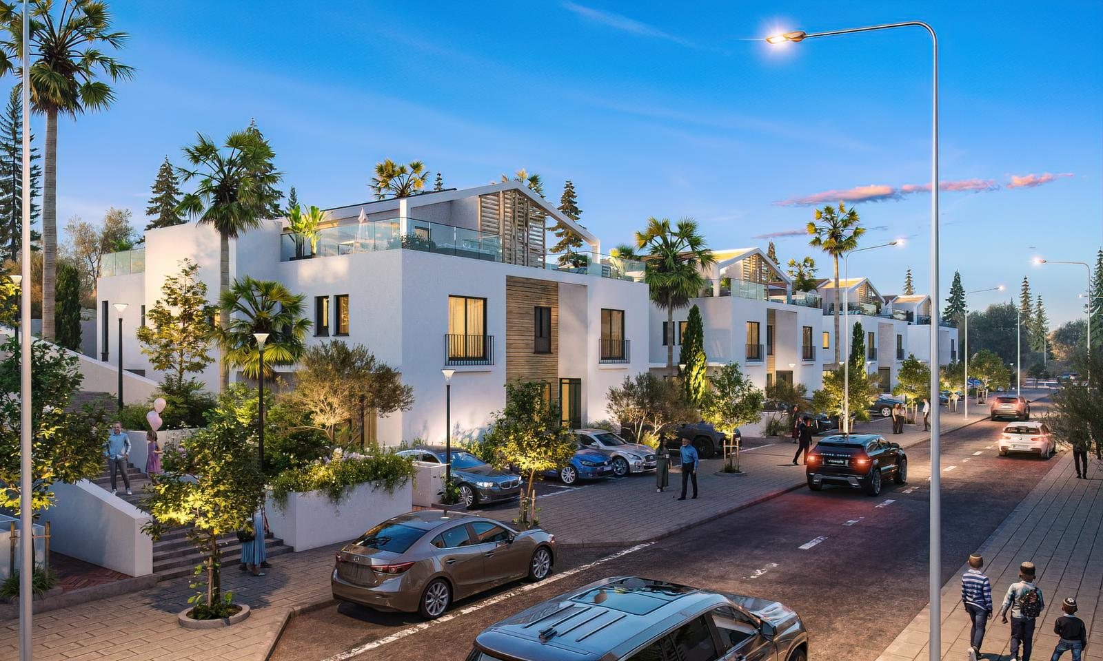 Evening view along the residential street at Mevo Modi'im with families walking between the new homes