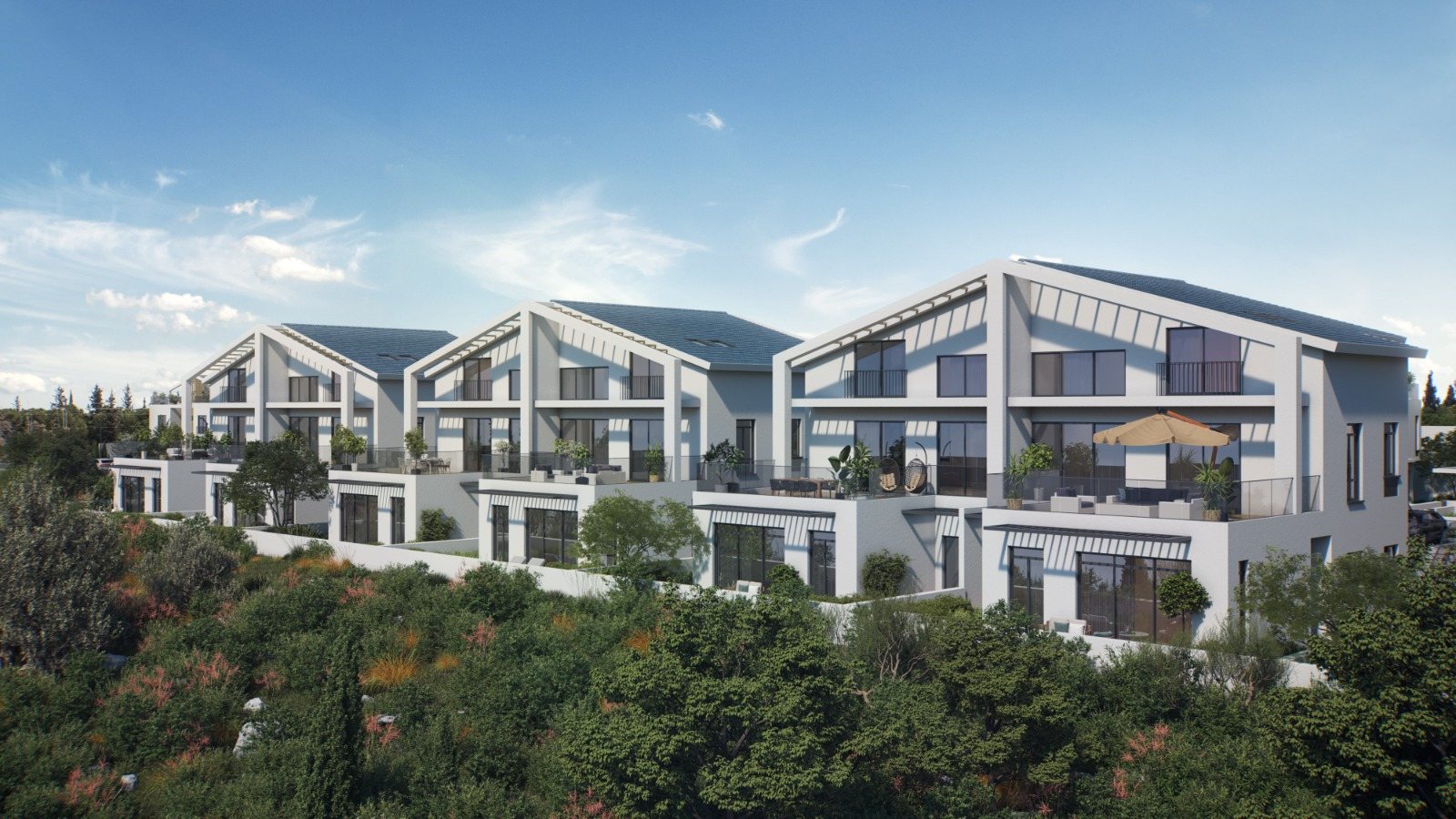 Row of pitched-roof homes with stepped terraces at Mevo Modi'im seen from the forest